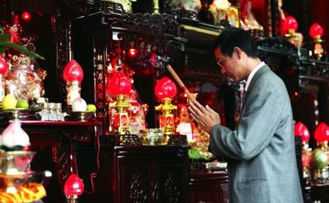 Chinese man paying respects to his ancestors