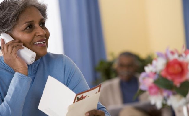 Woman on phone reading a greeting card