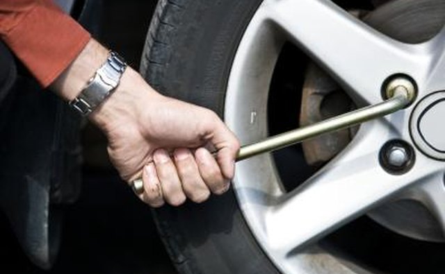 Tightening lugnuts on tire.