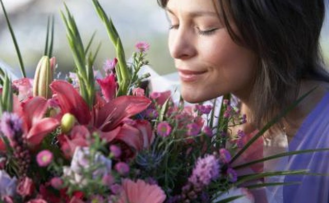 Woman smelling bouquet of flowers