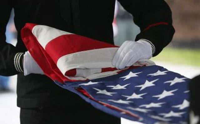The flag code specifies that when a casket is closed, the flag must be draped across the casket so that the