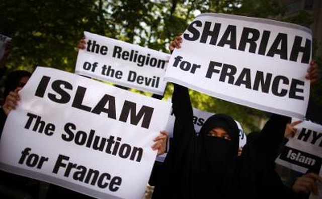 Demonstrators protest over a ban on women covering their faces in France.
