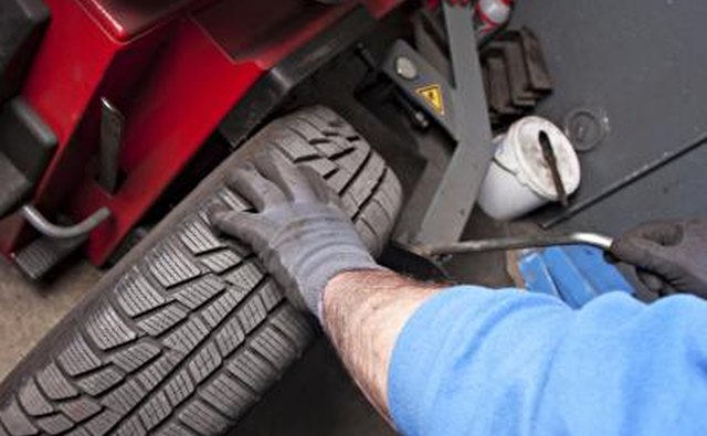 Mechanic repairing car alignment.