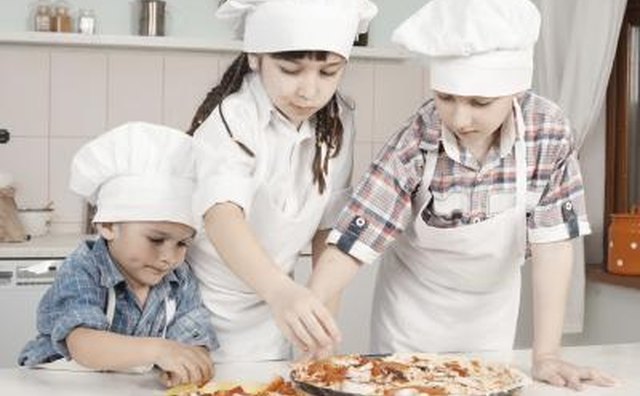 Young children making a pizza