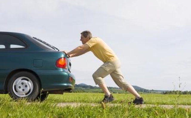 Man pushing down on car