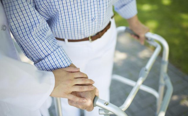 Senior man using walker outdoors