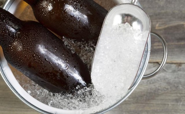 Two bottles of craft beer on ice.