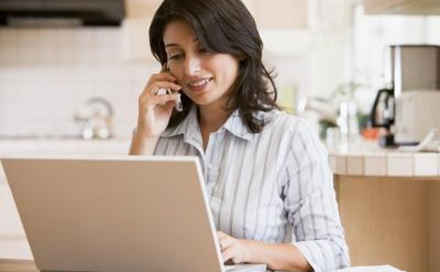 woman on computer and phone