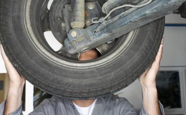Mechanic inspecting wheel