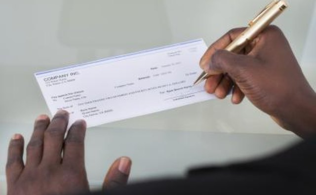 Businessman writing check
