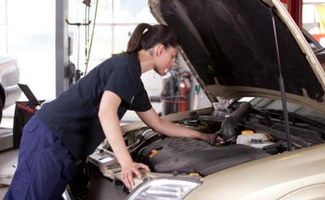 car mechanic looking at engine