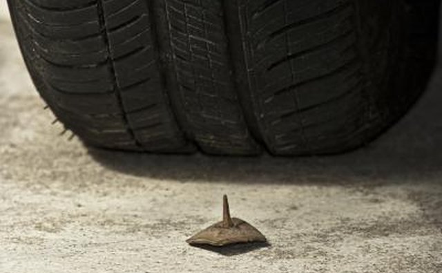 Nail in front of car tire