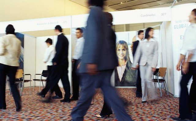 Walking by booths at trade show