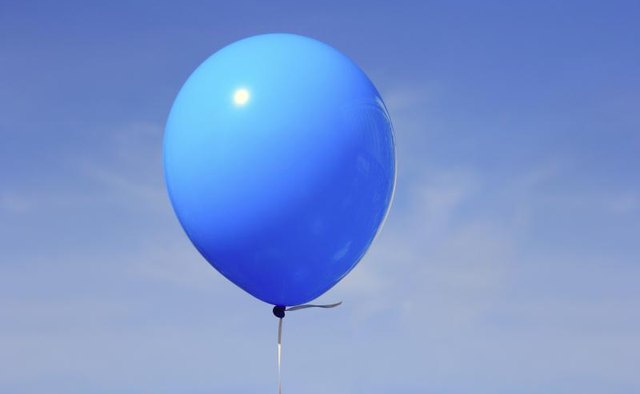 A blue balloon in the sky.
