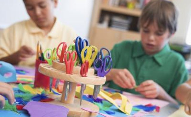 Children doing craft projects with scissors.