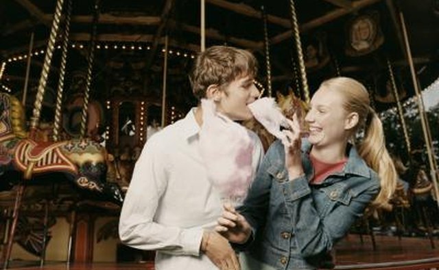 Teenage girl laughs and holds cotton candy