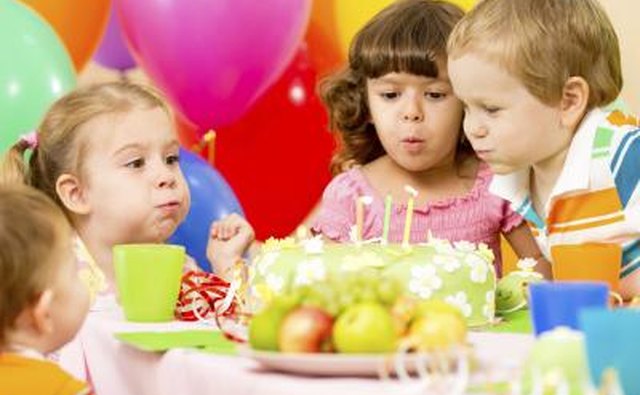 Children blowing out candles