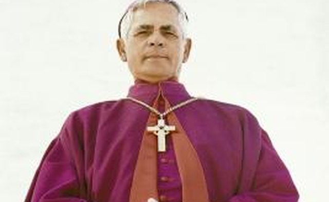 The priest wears a violet stole to administer the Sacrament of Penance.