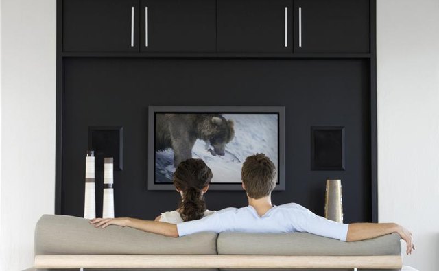 A couple watching TV in their living room