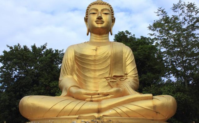 A large gold statue of the Buddha