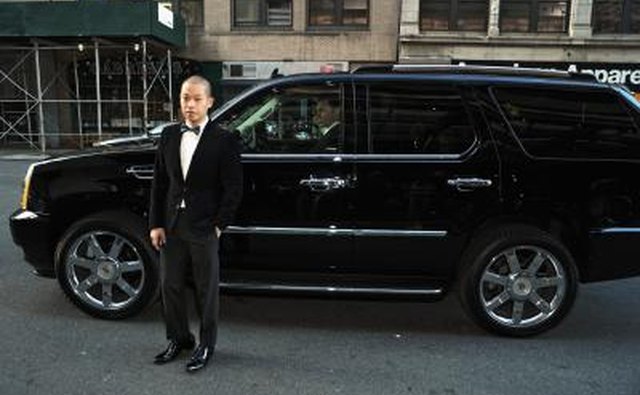 A man standing next to an Escalade