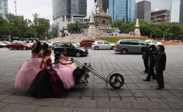 Quinceanera girls pose on a chopper in Mexico City