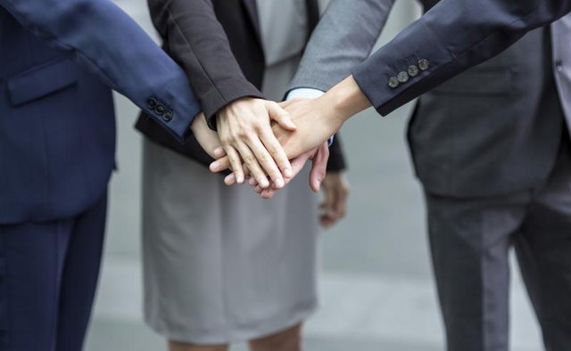 A team of office workers making a pact.