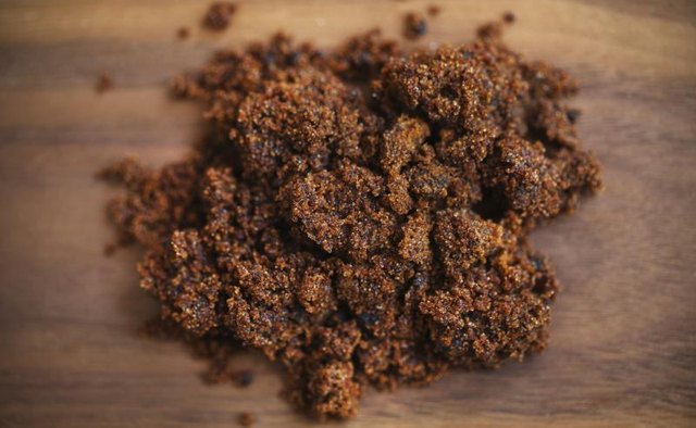 Brown sugar molasses on a wood table.