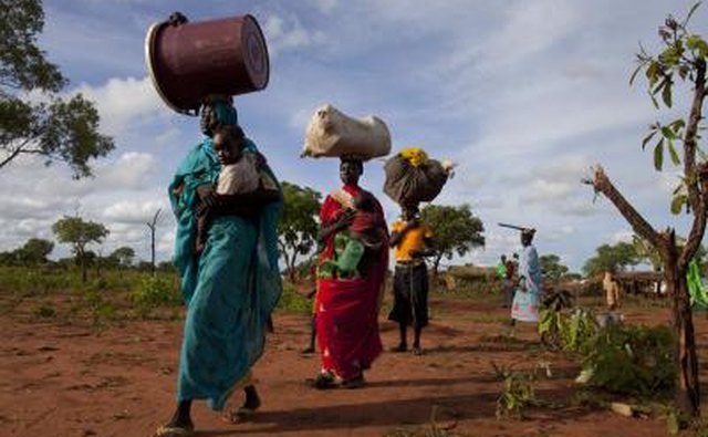 Sudanese villagers walking on road