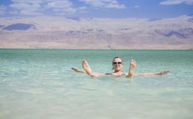 Woman floating in the Dead Sea
