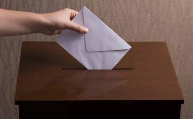 Hand casting ballot into box.