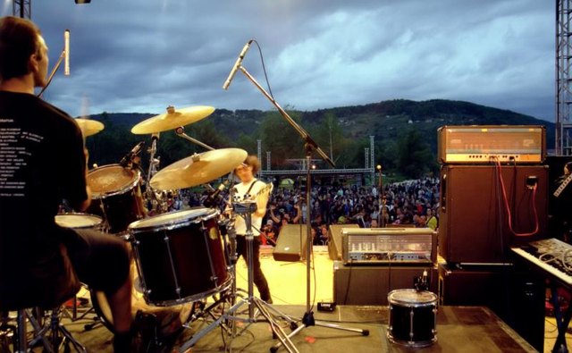 A band competing on a music stage.