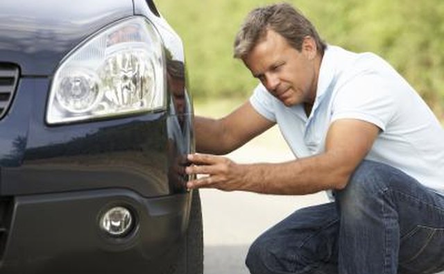 man assessing tire