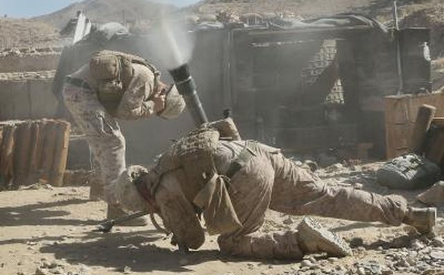 Marines fire mortar rounds to help their fellow Marines in a firefight