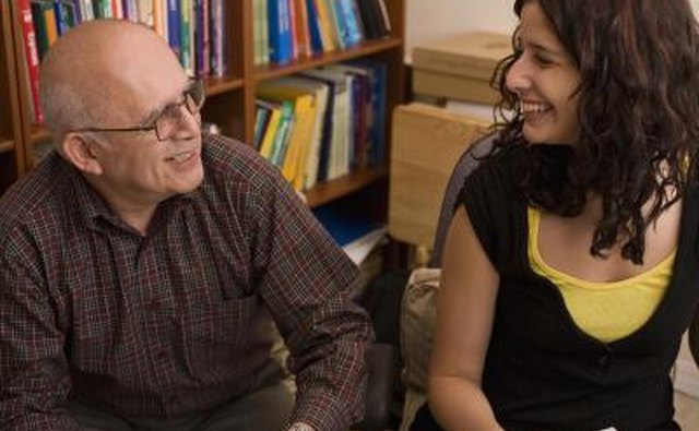 Two people smiling at one another before a book club meeting.