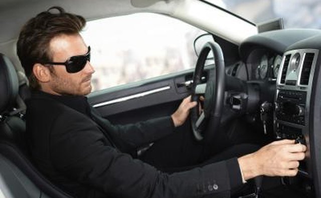 Man trying to use electric devices in car