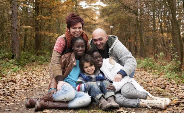 A portrait of a family with adopted children.