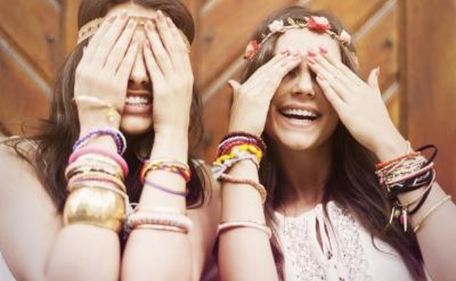 Two hippy girls wearing friendship bracelets.
