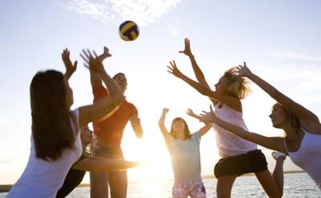 Youth group playing game at beach