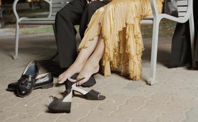 Couple on park bench with removed shoes