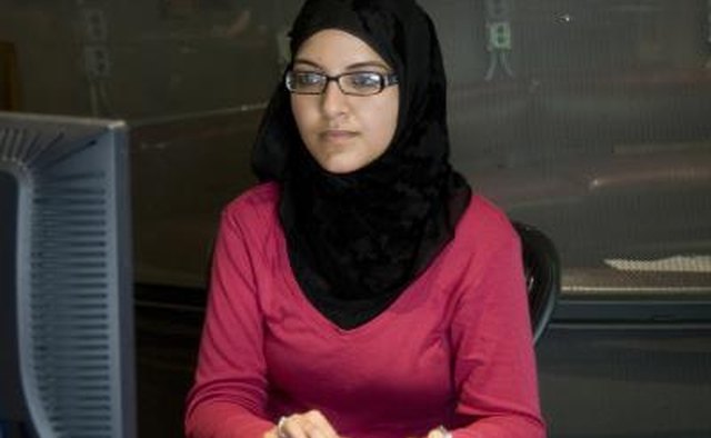 Young muslim woman typing at the computer