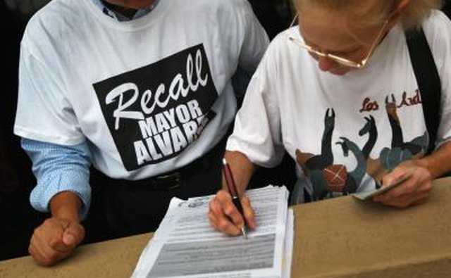 Marie Bond signs a petition to recall Miami-Dade County Mayor Carlos Alvarez