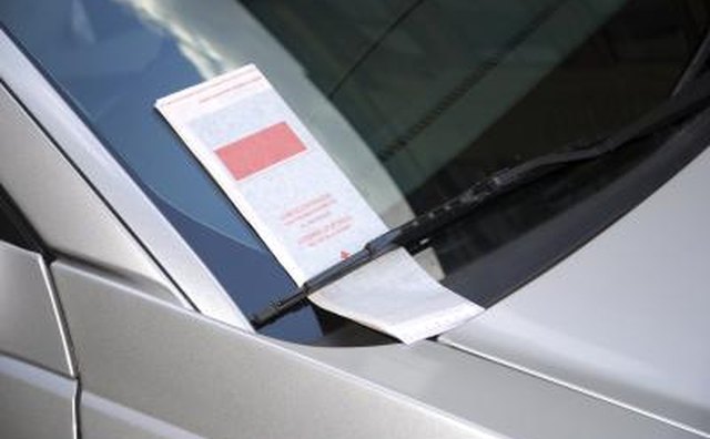 Leave what looks to be a parking ticket on her windshield.