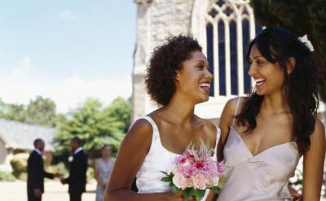 Bride and bridesmaid standing outside church