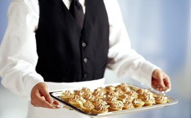 A professional caterer with a tray of food.