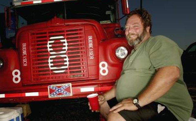Man with his customized bus at racing event