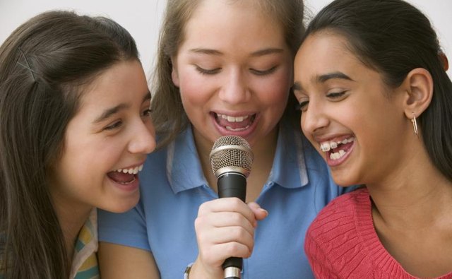 Girls singing into microphone