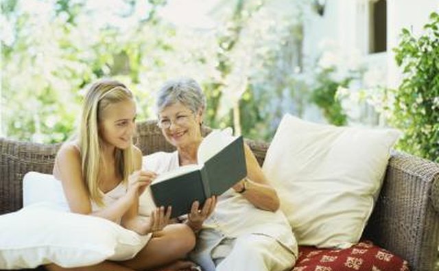 Girl reading with senior woman on couch