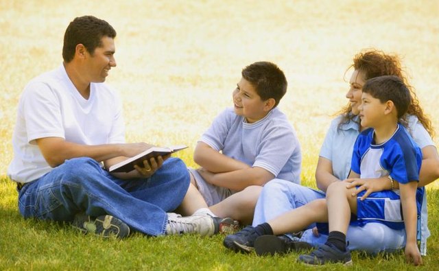 Man giving a sermon to children