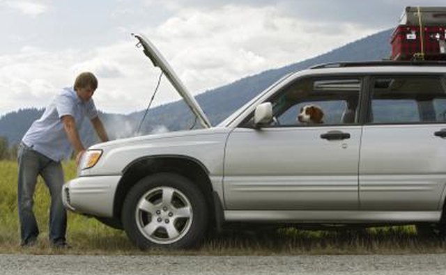 man inspecting car engine